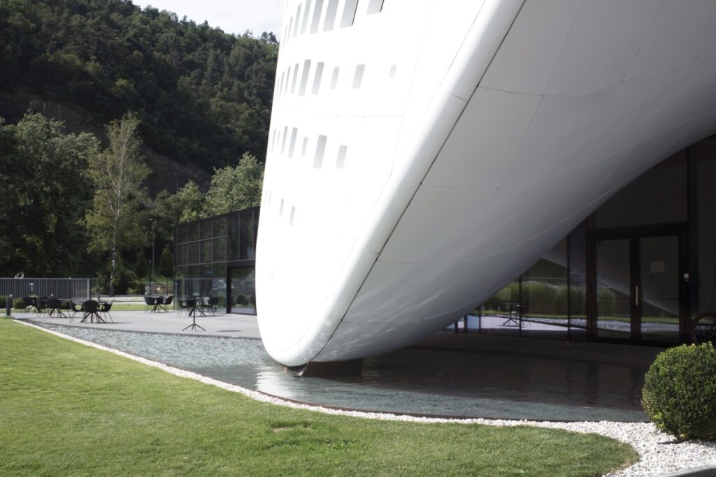Eine pixelige weiße Welle der ikonische Hauptsitz der Durst Group AG. MPV-Design. ph Luca Gardens